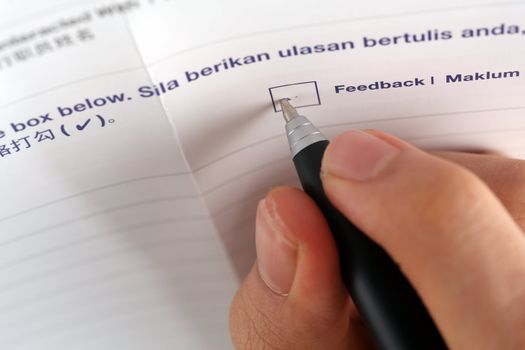 pen marking check boxes, close up