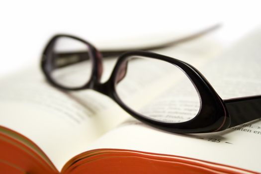 Glasses on an open book. Shallow depth of field.