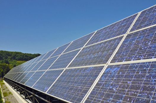 bright highly detailed solar panels stand under clear blue sky