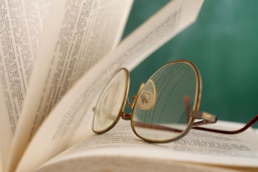 open page at glasses resting on the book