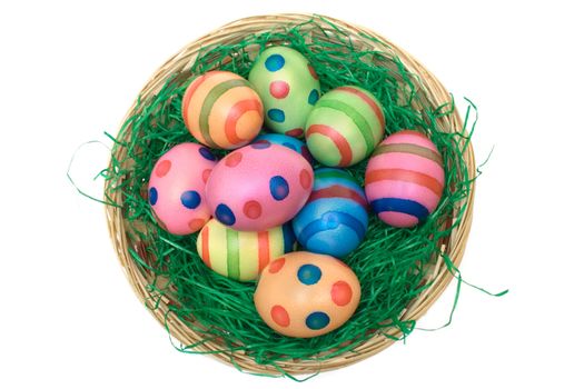 Easter eggs in a wooden basket. Isolated on a white background.