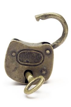 Antique grungy padlock with key. Isolated on white.