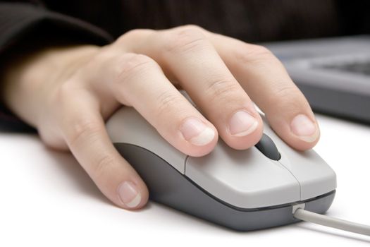 Detail shot of a businesswoman working on a laptop. White background.