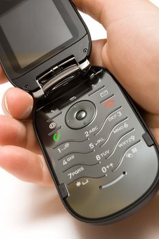 Woman holding an old-fashioned mobile phone. Isolated on a white background.