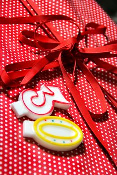 Beautiful present box with red bow and candles