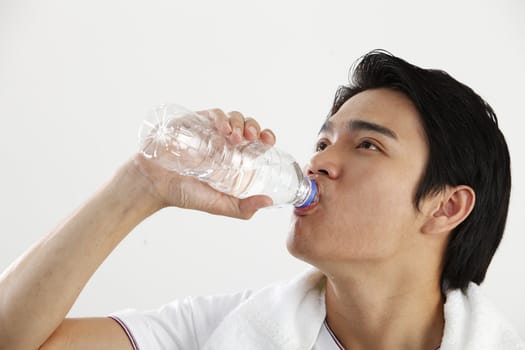 man drinking water from bottle