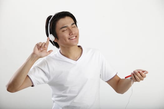 Young man listening to music on an smart phone