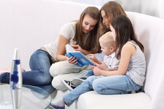 Mother Sitting With Children Reading Story