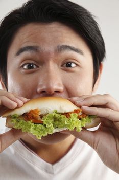 man eating burger on the white background