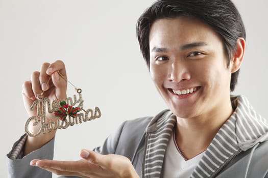 man holding a sign saying ' Merry Christmas' 

