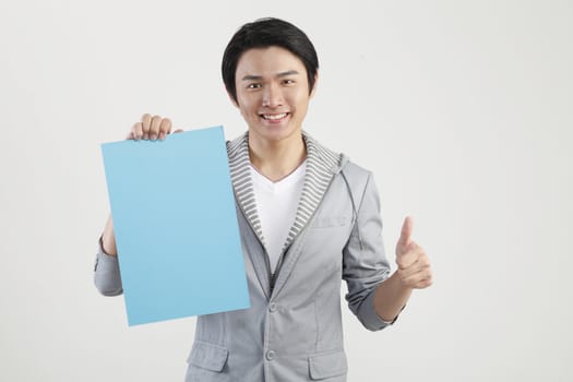 man holding cardboard with thumbs up