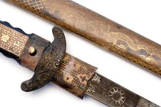 Detail shot of an ancient sword. Isolated on a white background.