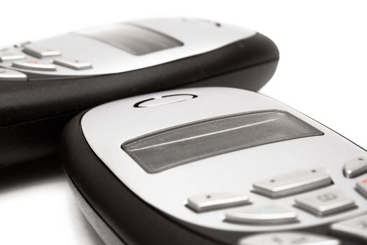 Two old-fashioned cell phones isolated on a white background.