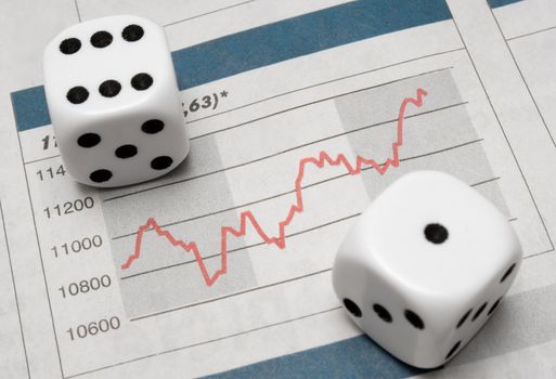 Pair of dice on stock chart.