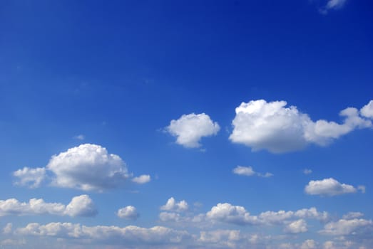 Blue sky background with tiny clouds