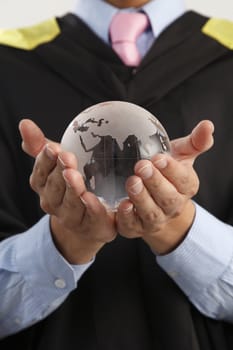 mid section of the man holding glass globe