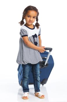 The young mulatto traveler girl with a suitcase. Isolated over white background. Vertical view