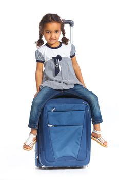 The young mulatto traveler girl with a suitcase. Isolated over white background. Vertical view