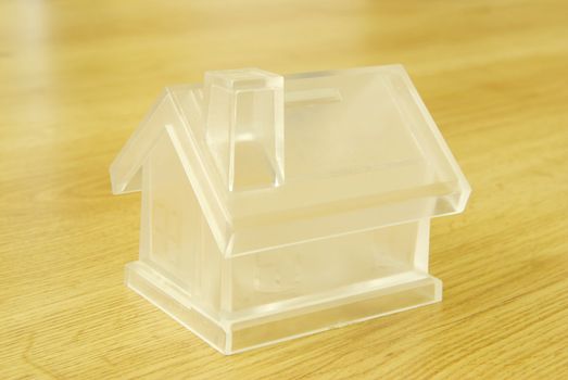 Crystal house isolated on wood background