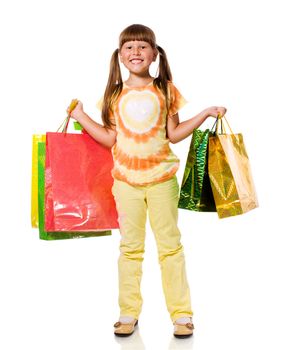 Smiling six years Girl holding presents bags isolated