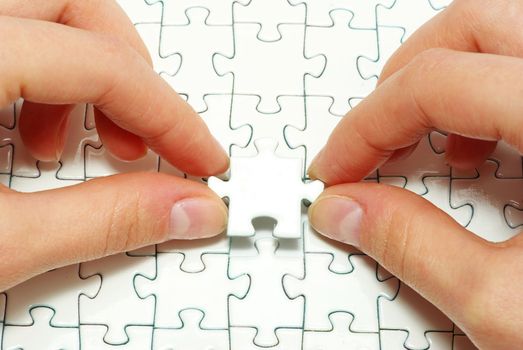 hands holding a puzzle piece . business concepts