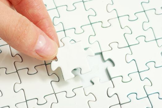 hands holding a puzzle piece . business concepts
