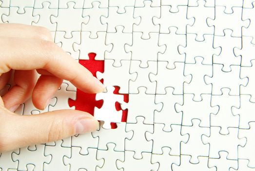 hands holding a puzzle piece . business concepts