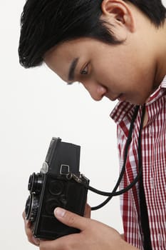 side view of man holding antique camera
