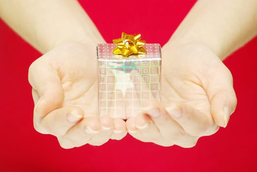 christmas gift in hands isolated on red 