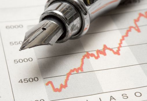 Close-up on a fountain pen on a financial data chart.