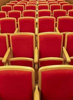 Red wooden chairs in the theater auditorium