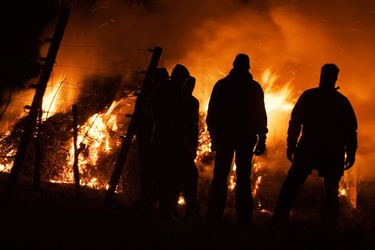 People watching a raging fire.