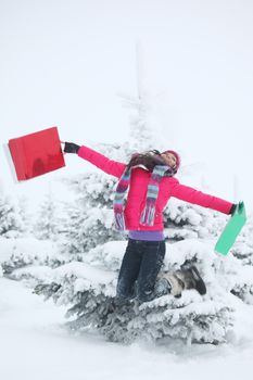 winter girl jump with gift on snow background