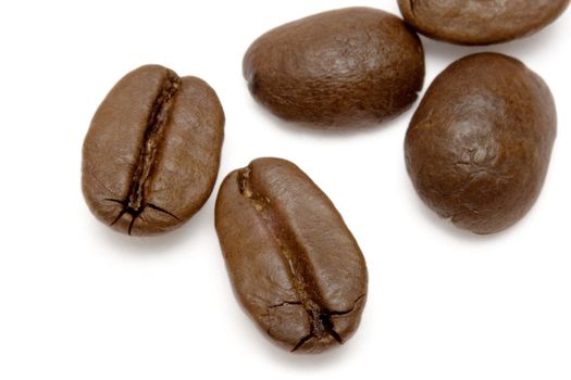 Roasted coffee beans isolated on a white background.