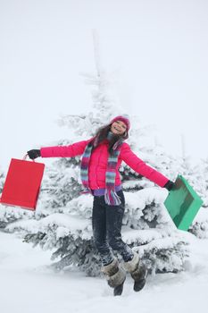 winter girl jump with gift on snow background