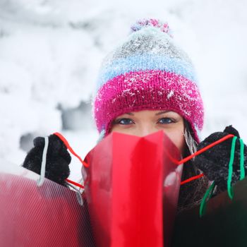 winter girl with gift bags on snow background