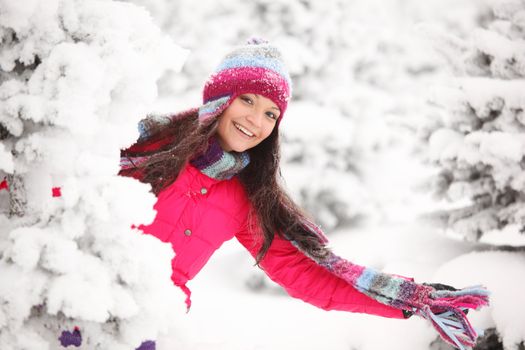 winter girl behind snow tree 