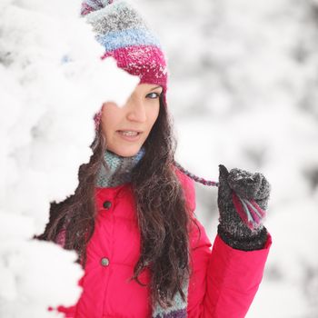 winter girl behind snow tree 