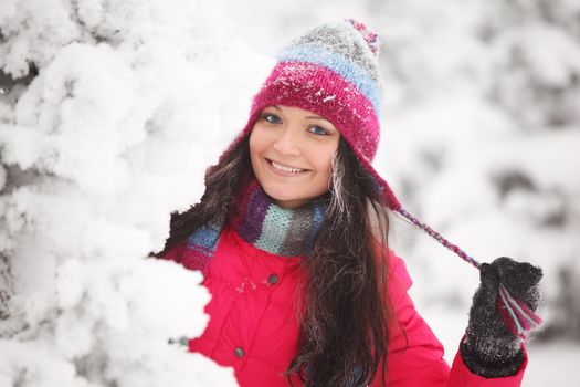 winter girl behind snow tree 