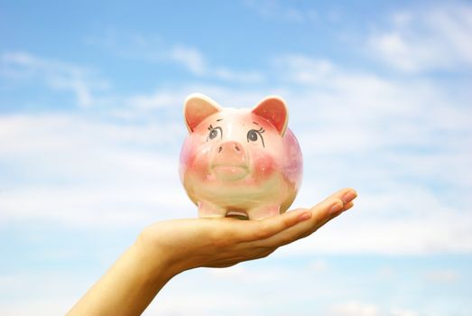 saving money  woman hands holding piggy bank