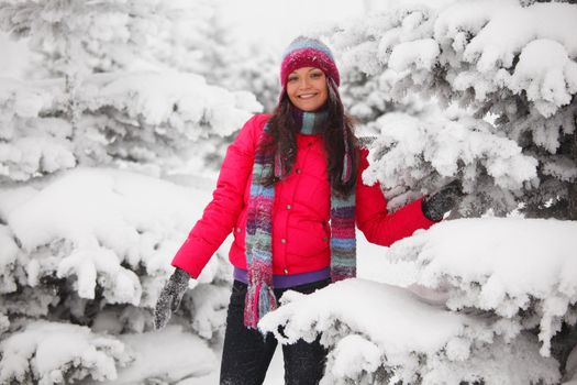 winter girl behind snow tree 