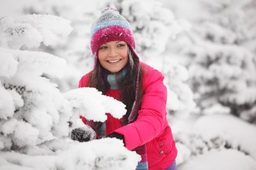 winter girl behind snow tree 