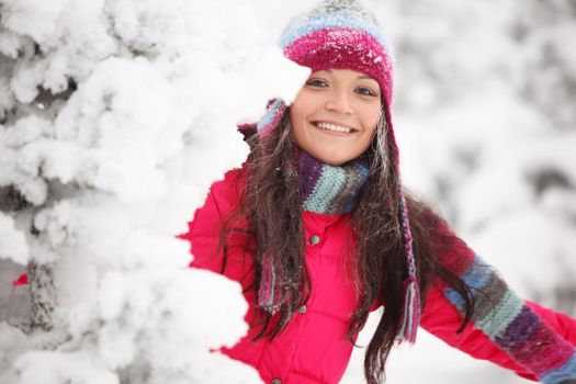 winter girl behind snow tree 