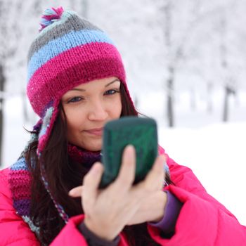 winter woman looking in mirror