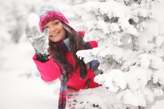 winter woman play snowballs on snow background