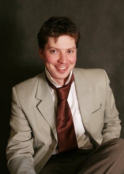 Smiling man in studio on a black background