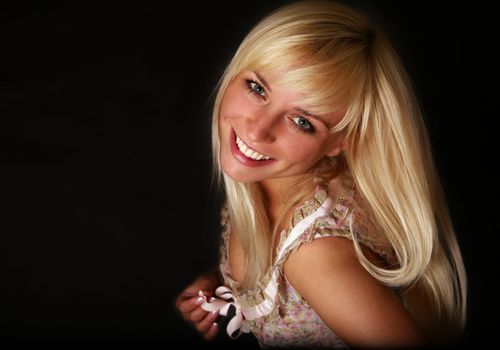 Portrait of smiling girl on a dark background