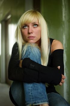 Portrait of the thoughtful girl sitting on a floor