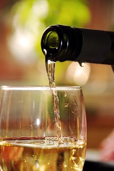 pour wine from green bottle into glass