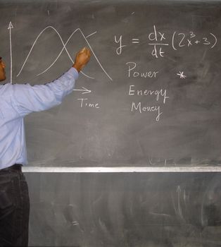 Teacher writing on blackboard